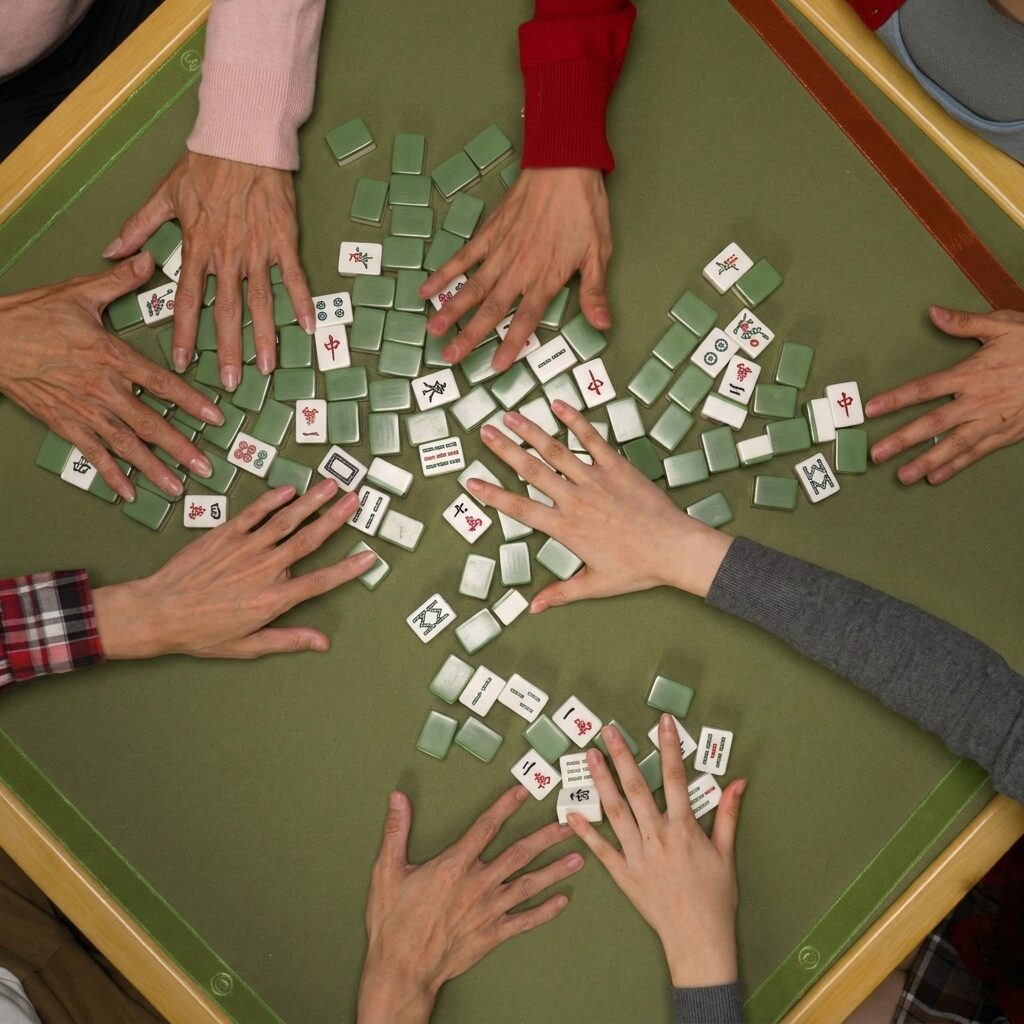 A welcoming Mahjong circle gathered around the table