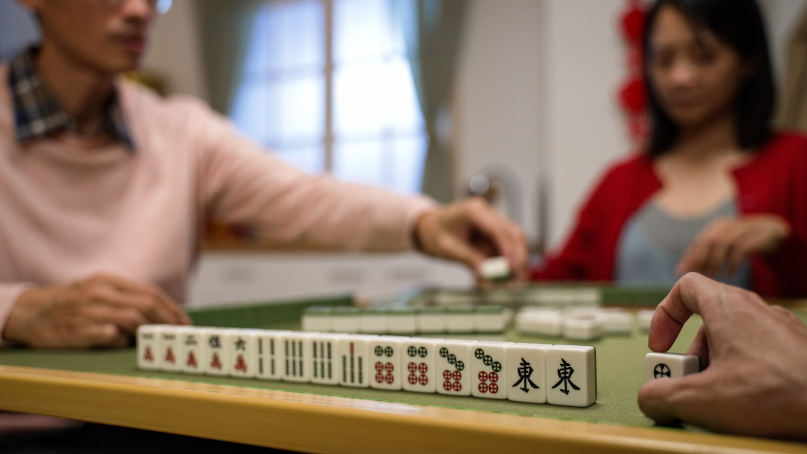 Players of all ages enjoying Mahjong together